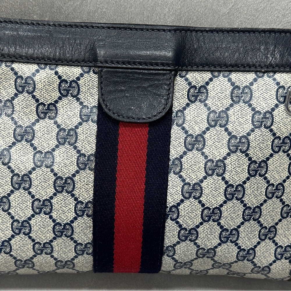 Authentic Gucci Signature blue clutch with added D-rings. Preowned